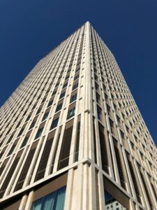 Impressive low angle shot capturing a modern skyscraper with clear blue sky, ideal for architecture themes.